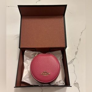 Coach- Dusty Pink Round Pebbled Leather Zip
Around Jewelry Case